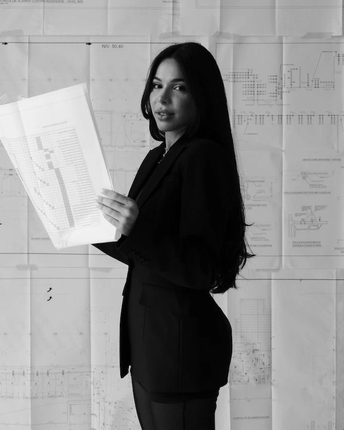 Portrait of Mariam Albornoz Biscardi, assistant project manager at Heartwood Development Partners, holding a set of drawings